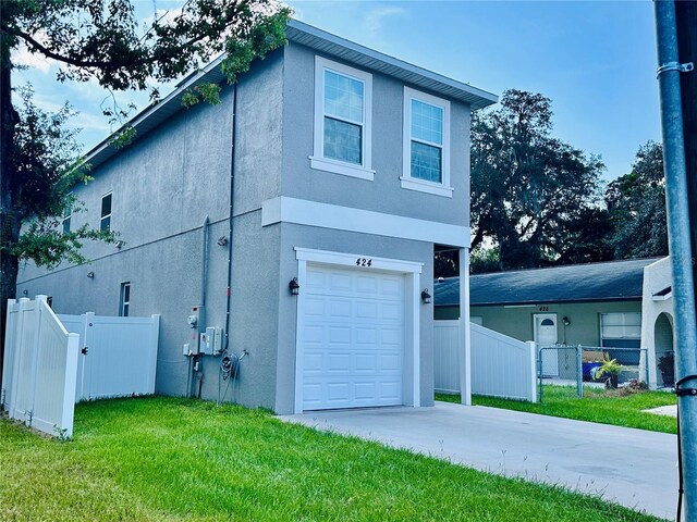 view of front of home with a garage and a front yard