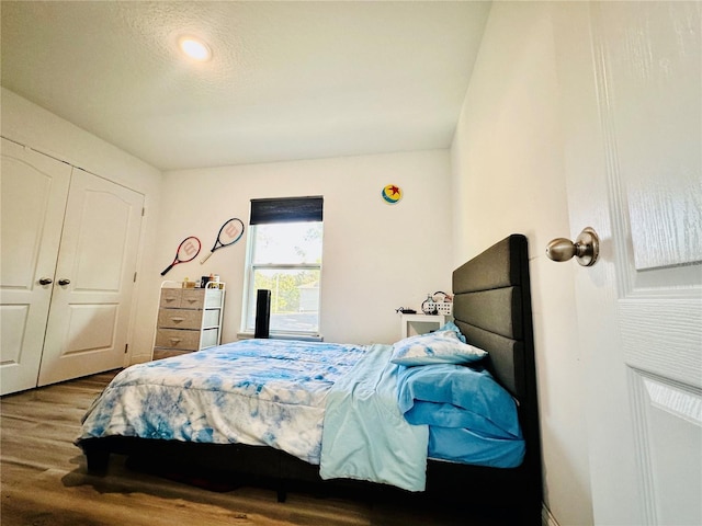 bedroom with hardwood / wood-style floors