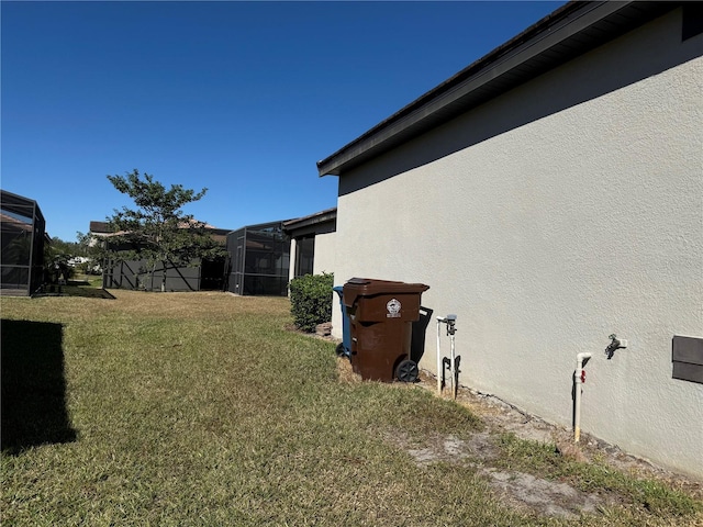 view of yard featuring glass enclosure