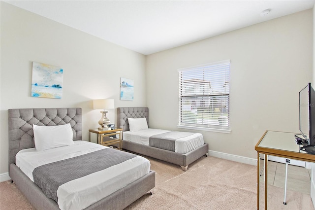 bedroom featuring light carpet