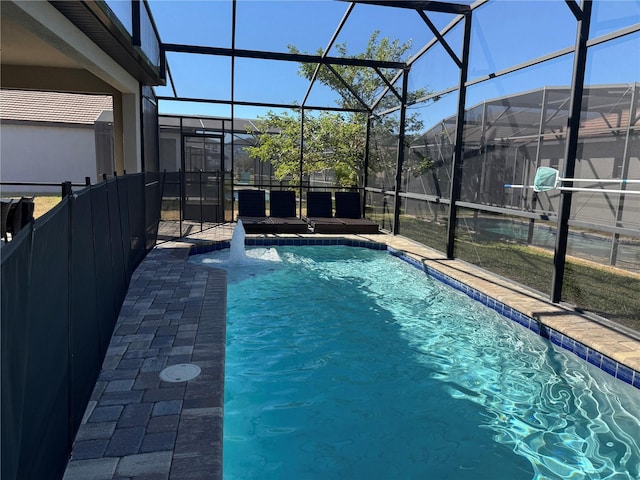 view of swimming pool featuring glass enclosure