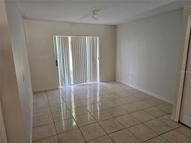 unfurnished room with light tile patterned flooring