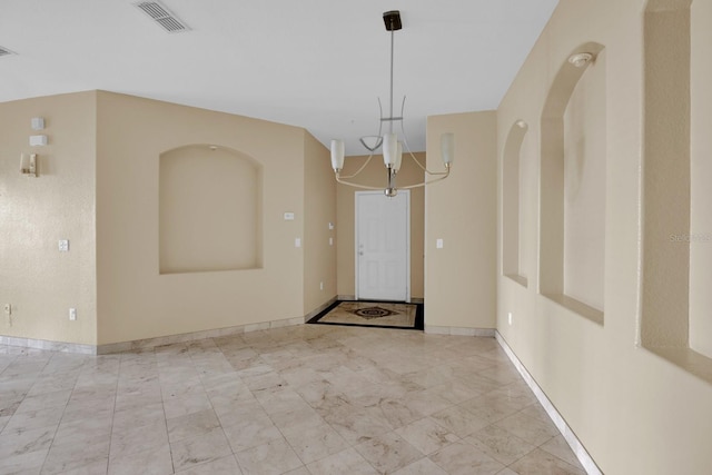 entryway with a notable chandelier