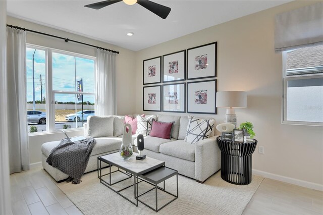 living room featuring light hardwood / wood-style floors and ceiling fan