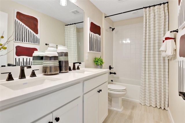 full bathroom featuring toilet, shower / bathtub combination with curtain, and vanity