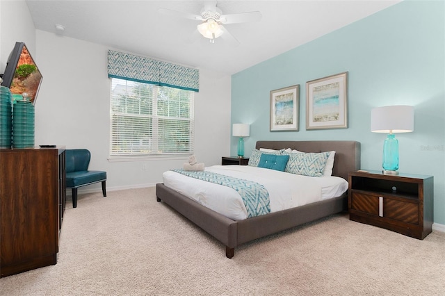 carpeted bedroom featuring a ceiling fan and baseboards