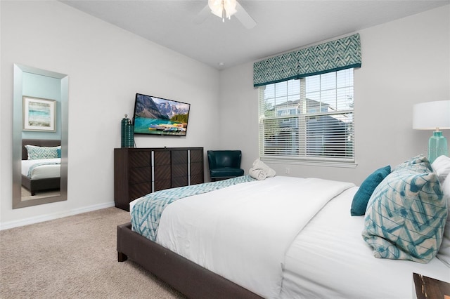 carpeted bedroom with a ceiling fan and baseboards