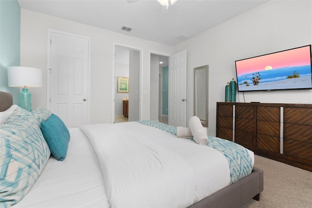 bedroom featuring ceiling fan, carpet, and connected bathroom