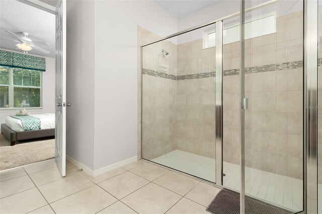 bathroom featuring ceiling fan, tile patterned floors, and a shower with shower door