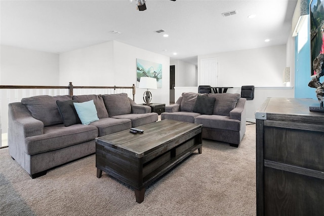 living area with recessed lighting, visible vents, and carpet floors