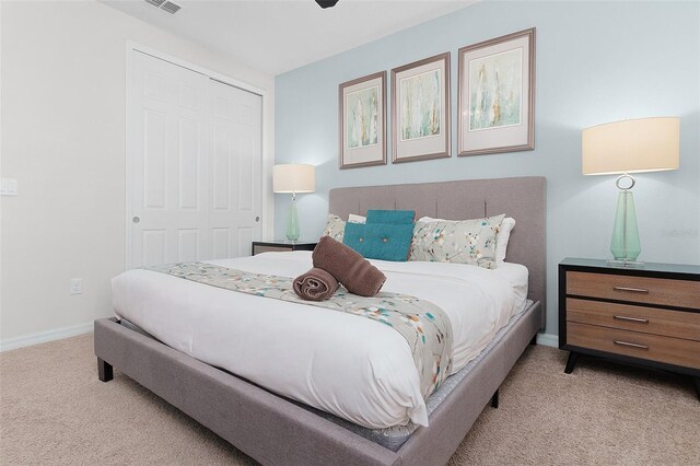 carpeted bedroom featuring ceiling fan and a closet