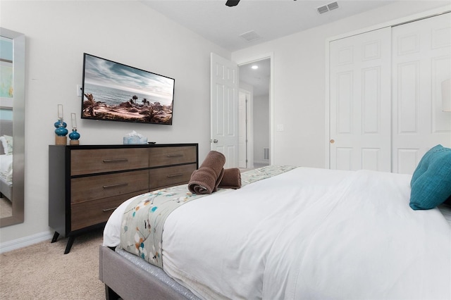 carpeted bedroom featuring a closet and ceiling fan