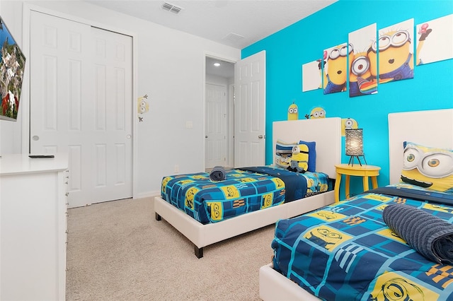 carpeted bedroom featuring a closet