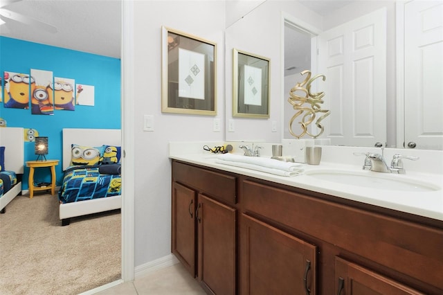 bathroom featuring ceiling fan, a textured ceiling, and dual vanity