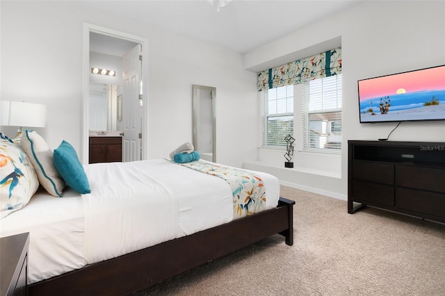 carpeted bedroom featuring ensuite bath