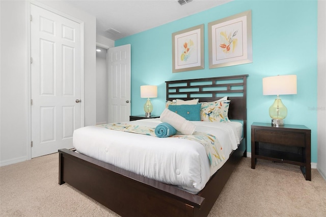 bedroom with visible vents, baseboards, and carpet