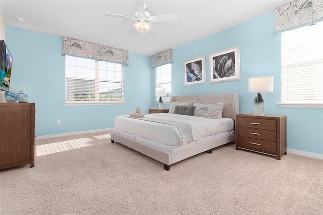 bedroom featuring ceiling fan and light carpet