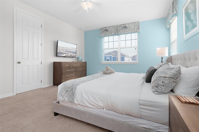 bedroom with a ceiling fan, carpet, and baseboards