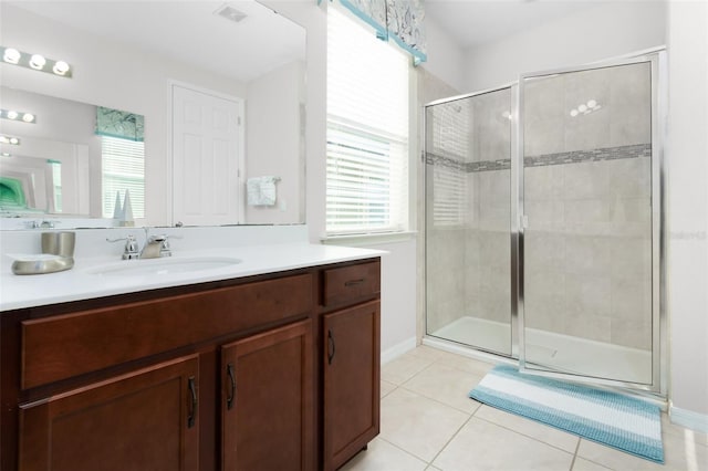 bathroom featuring a shower with door, tile patterned floors, and vanity