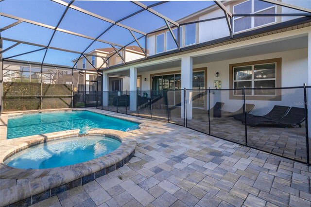 view of pool featuring a lanai, an in ground hot tub, and a patio