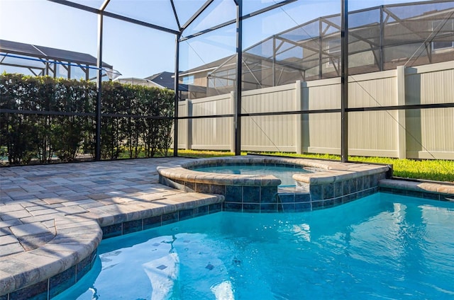 view of pool featuring an in ground hot tub and glass enclosure