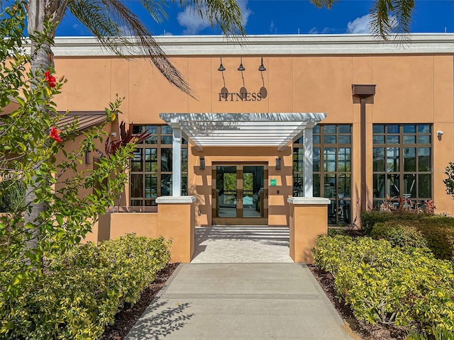 entrance to property with french doors and stucco siding