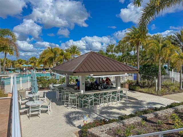 view of community featuring a swimming pool and a patio area