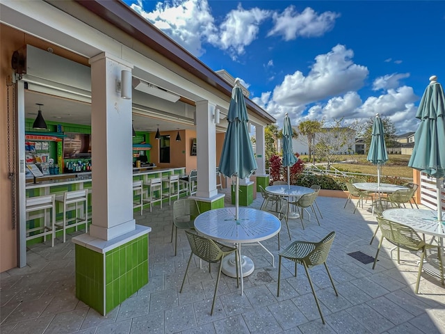 view of patio featuring an outdoor bar