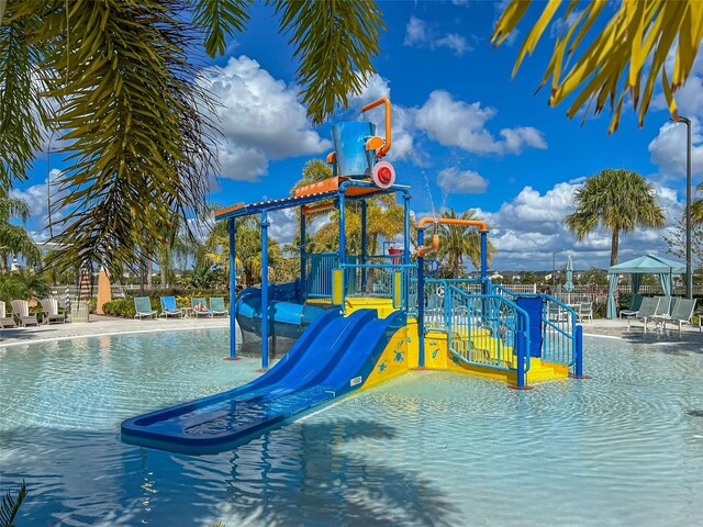 view of playground featuring a community pool