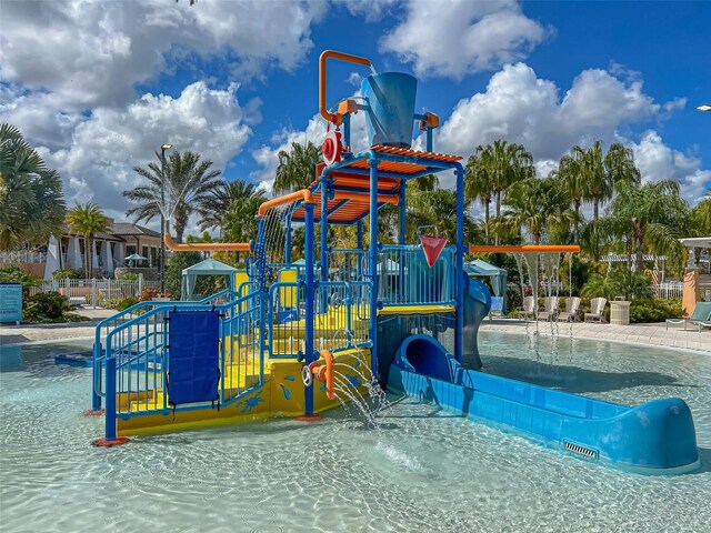 view of jungle gym with a community pool