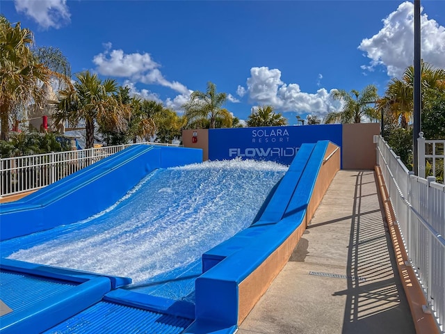 view of swimming pool with fence