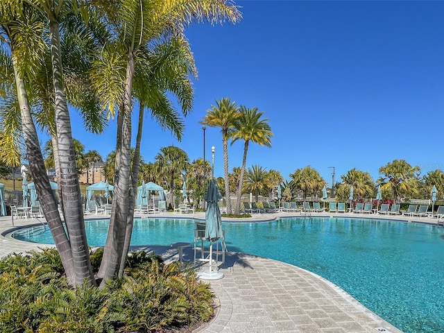 pool with a patio and fence