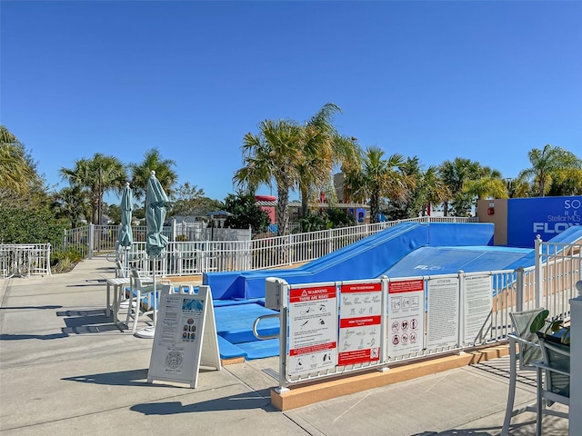 view of home's community featuring fence