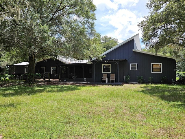 back of house with a lawn