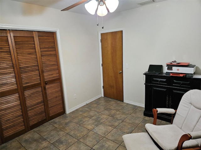 office area featuring ceiling fan and dark tile patterned floors