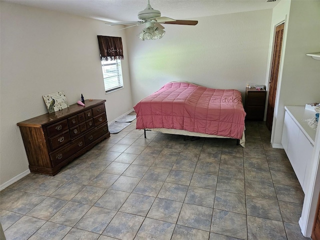 tiled bedroom featuring ceiling fan