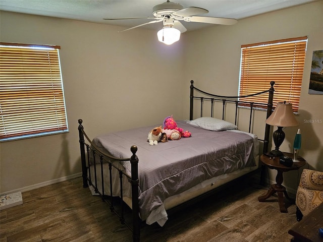 bedroom with ceiling fan and dark hardwood / wood-style floors