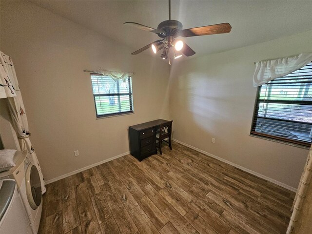 interior space featuring hardwood / wood-style floors, vaulted ceiling, washer / dryer, and ceiling fan