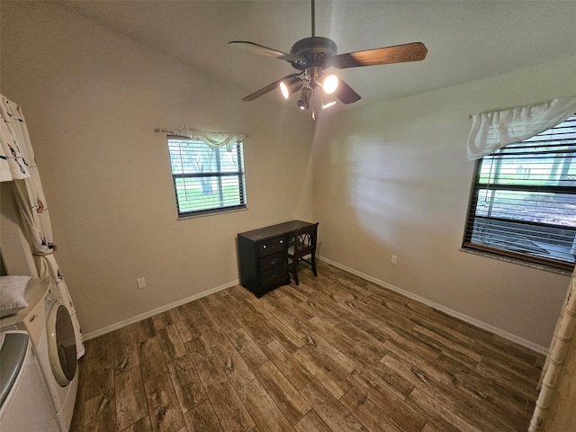 interior space with ceiling fan, dark wood-type flooring, and washer / dryer