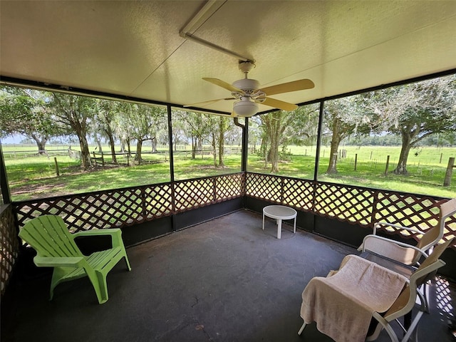 sunroom / solarium featuring ceiling fan