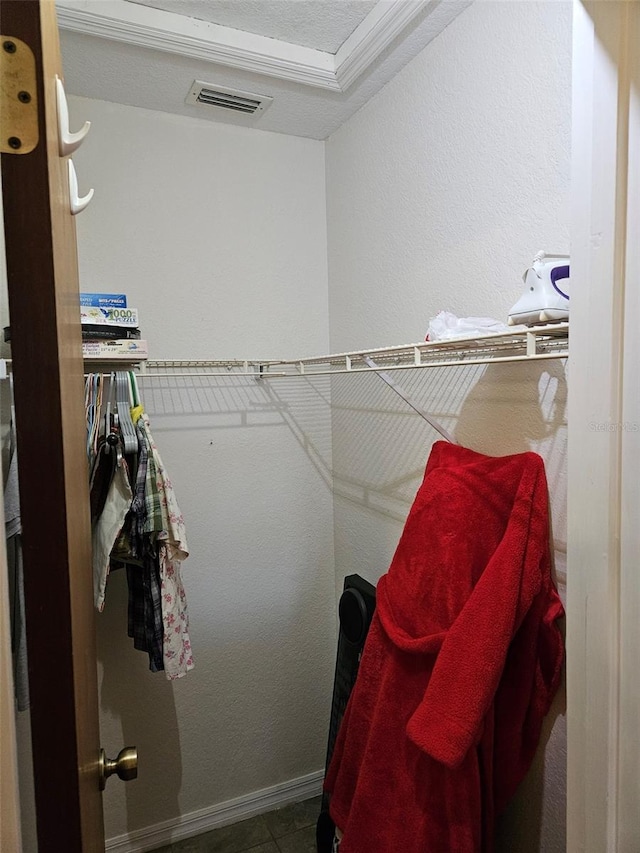 spacious closet with tile patterned floors