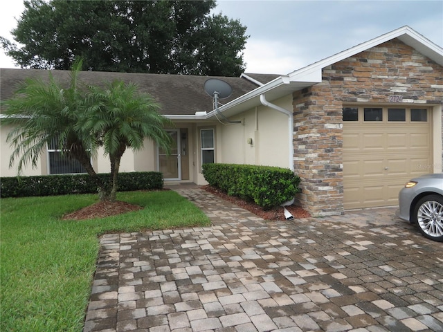 view of front of property with a garage and a front yard