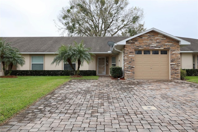 ranch-style home featuring a garage, stone siding, a front yard, and stucco siding