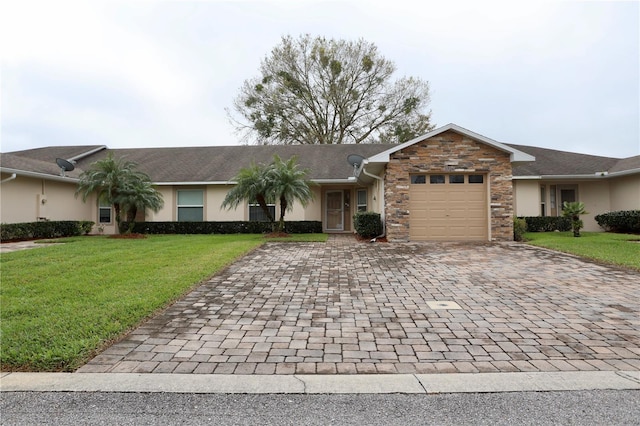 single story home featuring an attached garage, stone siding, decorative driveway, stucco siding, and a front lawn