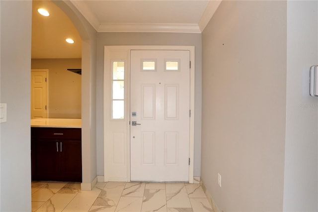 entrance foyer featuring crown molding, arched walkways, marble finish floor, and baseboards