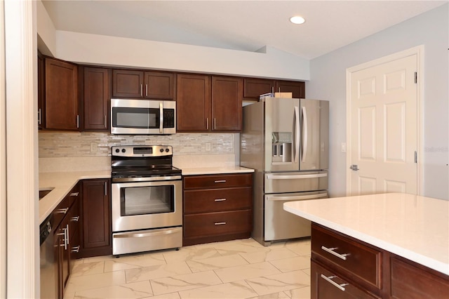 kitchen featuring backsplash, marble finish floor, appliances with stainless steel finishes, and light countertops