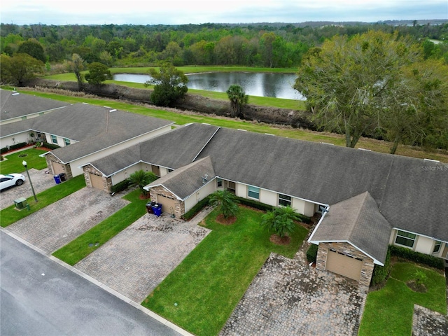 aerial view with a wooded view and a water view