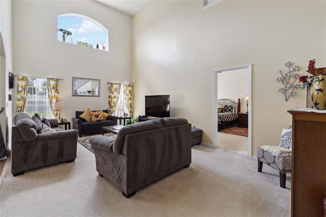 241 Grosvenor Loop, Davenport, FL 33897 - living room with a towering ceiling, light carpet, and baseboards
