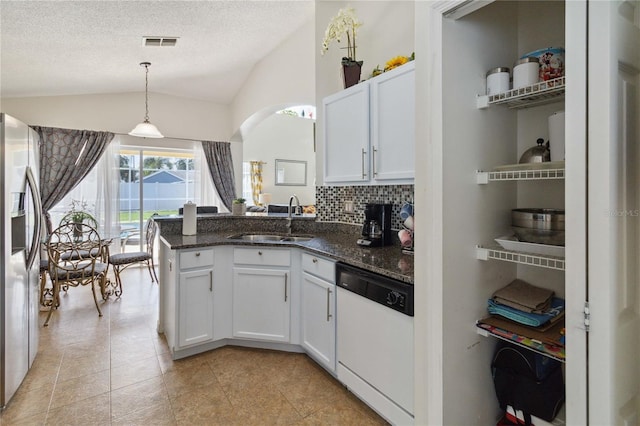 241 Grosvenor Loop, Davenport, FL 33897 - kitchen with dishwasher, a sink, stainless steel fridge with ice dispenser, vaulted ceiling, and a peninsula