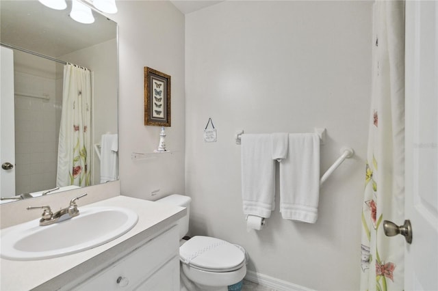 bathroom featuring toilet, vanity, and a shower with curtain